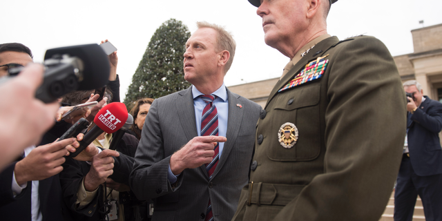 Acting Secretary of Defense Patrick Shanahan, center, and Chairman of the Joint Chiefs Gen. Joseph Dunford, right, talk to the press before the arrival of Turkish Defense Minister Hulusi Akar on Friday, Feb. 22, 2019 at the Pentagon in Washington. (AP Photo/Kevin Wolf)