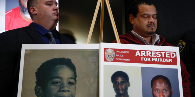 Hubert Tillett, right, brother of William Tillett, stands behind a display showing his brother, bottom left, during a news conference Wednesday, Feb. 20, 2019, in Inglewood, Calif. Authorities say a 50-year-old man is in custody in connection with the kidnapping and killing of then 11-year-old William Tillett in Southern California nearly three decades ago. (AP Photo/Jae C. Hong)