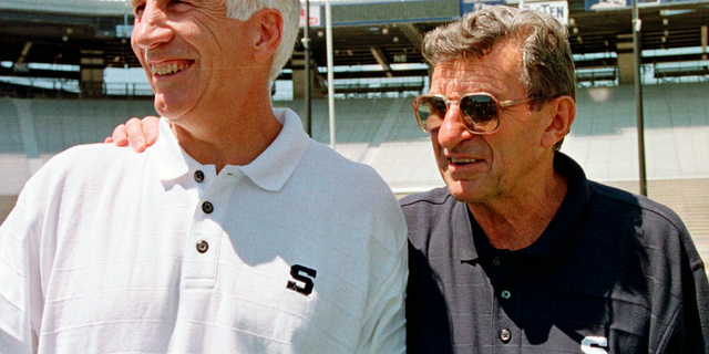 FILE - In this Aug. 6, 1999, file photo, Penn State football coach Joe Paterno, right, poses with his defensive coordinator Jerry Sandusky, during the college football team's media day in State College, Pa. Alumni-elected Penn State trustees who successfully fought for access to records about a university-commissioned report into how complaints about Sandusky were handled describe it as unreliable and misleading, adding fuel to a debate over the scandal that has roiled for more than seven years. (AP Photo/Paul Vathis, File)