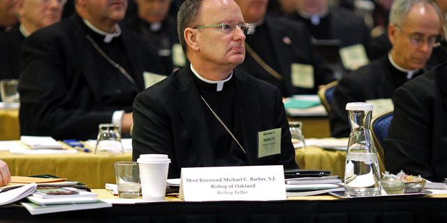 FILE - In this Nov. 12, 2013, file photo, Roman Catholic Diocese of Oakland Bishop Michael Barber, center, listens to a presentation alongside fellow bishops at the United States Conference of Catholic Bishops' annual fall meeting in Baltimore. The Catholic Diocese of Oakland, Calif., has released the names of 45 priests, deacons and religious brothers who officials say are "credibly accused" of sexually abusing minors. The San Francisco Chronicle says Monday that Oakland's list goes back to 1962, when the diocese was founded. None of the men are currently in the ministry. Of the 45 people named, 20 were priests. (AP Photo/Patrick Semansky, File)