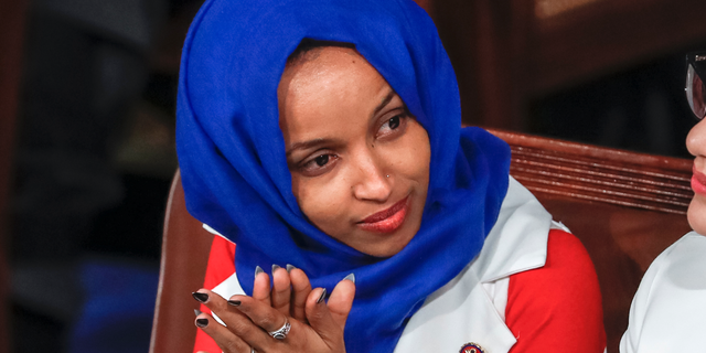 FILE - In this Feb. 5, 2019, file photo, Rep. Ilhan Omar, D-Minn., listens to President Donald Trump's State of the Union speech, at the Capitol in Washington. In Omar's Minnesota district, both Jews and Muslims voiced concern about an inflammatory tweet on Israel that had the congresswoman apologizing within hours. While some Jews said she was being unfairly judged, others said they feared she was being slow to learn from previous criticism. (AP Photo/J. Scott Applewhite, File)
