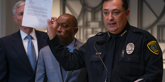 Houston Police Department Chief Art Acevedo holds up a letter from the FBI announcing the bureau's civil rights investigation related to the deaths of two people during the no-knock raid by narcotics officers that killed two people and injured five police officers last month, during a press conference from Houston City Hall, Wednesday, Feb. 20, 2019.