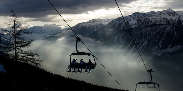 Ski racers sit on the chairlift in the early morning before the first run of the men's Alpine Skiing World Cup Giant Slalom race in Crans-Montana February 26, 2012. REUTERS