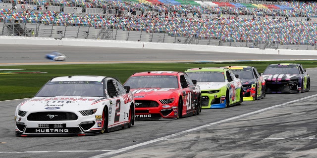 NASCAR drivers, from left, Brad Keselowski (2), Daniel Suarez (41), Tyler Reddick, William Byron and Jimmie Johnson wait on pit road for their turn on the track during auto racing practice for the Daytona 500 at Daytona International Speedway in Florida, Saturday. (AP Photo/John Raoux)