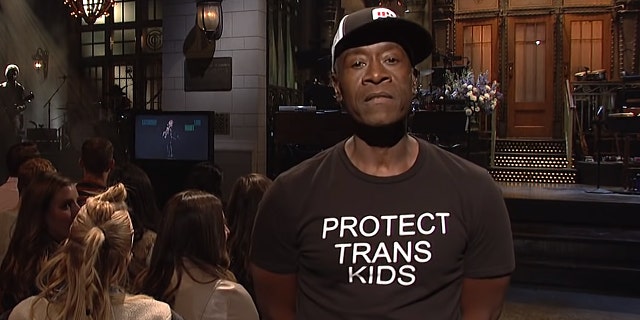 Don Cheadle wears a shirt reading "Protect Trans Kids" while hosting "Saturday Night Live."