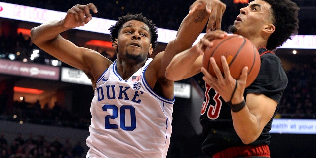 Duke center Marques Bolden (20) and Louisville forward Jordan Nwora (33) vie for a rebound during the first half of an NCAA college basketball game in Louisville, Ky., Tuesday, Feb. 12, 2019. (Associated Press)