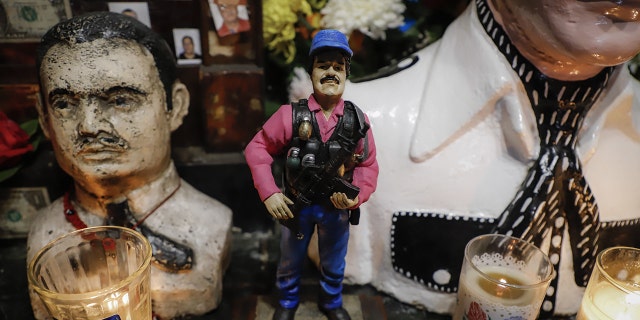A statue of Mexican drug lord Joaquin "El Chapo" Guzman, is displayed for sale near a bust of narco-saint Jesus Malverde, at his chapel in Culiacan, Sinaloa state in northwest Mexico, on February, 19, 2019
