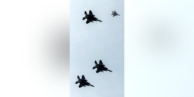 F-15 planes seen from Endcliffe Park in Sheffield, as warplanes from Britain and the United States stage a flyover in tribute to ten dead US airmen. Tony Foulds was just a child playing in the park on Feb. 22, 1944, when a U.S. Air Force crew decided to crash and die rather than take the chance of hitting the playing children.