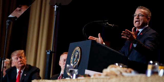 President Donald Trump listens as Gary Haugen, Chief Executive Officer and Founder of International Justice Mission, speaks during the National Prayer Breakfast, Thursday, Feb. 7, 2019, in Washington. (AP Photo/ Evan Vucci)
