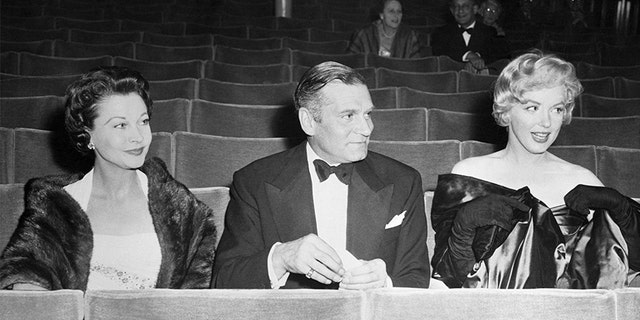 Seated in the stalls of the Comedy Theater for the London premiere of Arthur Miller's play, "A View From the Bridge," are Vivien Leigh, her husband, Sir Laurence Olivier, and Hollywood's Marilyn Monroe, wife of the author. The trio arrived early to avoid the rush. — Getty