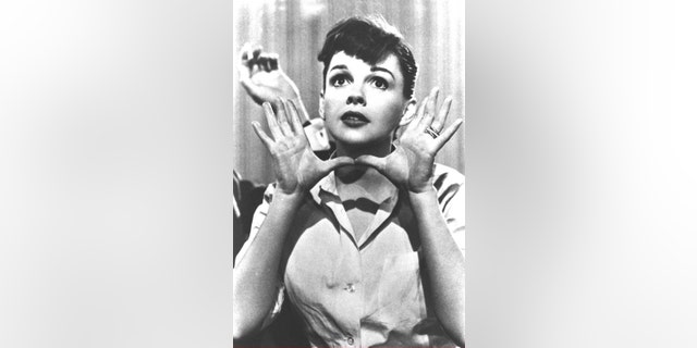Portrait of American popular singer and actress Judy Garland (1922 - 1969) as she makes the gesture later called "Jazz Hands," in a still from the film "A Star is Born," directed by George Cukor, circa 1954.