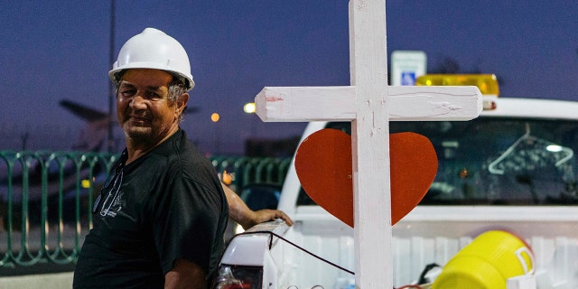 A memorial displaying 58 crosses by Greg Zanis stands at the Welcome To Las Vegas Sign Thursday, Oct. 5, 2017, in Las Vegas. (Mikayla Whitmore/Las Vegas Sun via AP)