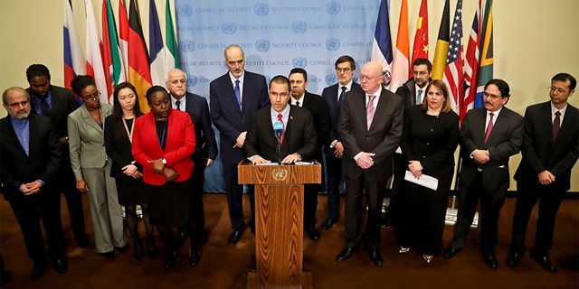 Venezuela Foreign Affairs Minister Jorge Arreaza, center, surrounded by diplomats from several countries including Russia, China, Iran and Syria, at Thursday's announcement. (AP Photo/Bebeto Matthews)