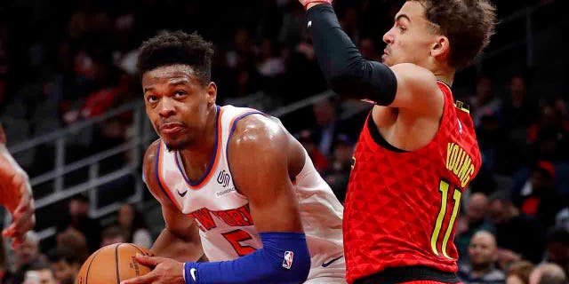 New York Knicks guard Dennis Smith Jr. (5) works against Atlanta Hawks guard Trae Young (11) during the second half of an NBA basketball game Thursday, Feb. 14, 2019, in Atlanta. New York won 106-91. (Associated Press)