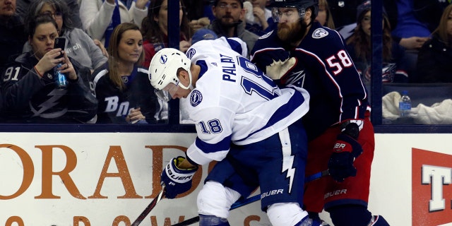 Tampa Bay Lightning forward Ondrej Palat, left, of the Czech Republic, works against Columbus Blue Jackets defenseman David Savard during the second period of an NHL hockey game in Columbus, Ohio, Monday, Feb. 18, 2019.