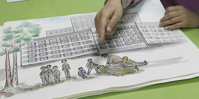 In this Dec. 21, 2018, photo, North Korean defector Kwak Jeong-ae, 65, shows a drawing about North Korea during an interview in Uijeongbu, South Korea. Experts and defectors say most of North Korea’s underground Christians do not engage in the extremely dangerous work of proselytizing. Instead, they largely keep their beliefs to themselves or within their immediate families.