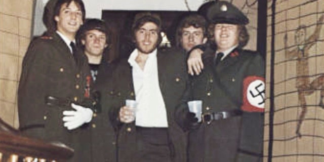 In this photo from the 1980 edition of Spectrum, the Gettysburg College yearbook, Bob Garthwait, right, wears a costume that depicts a Nazi uniform at a fraternity event. Garthwait, a financial donor and college trustee, apologized and announced his resignation from the board of trustees Tuesday, Feb. 19, 2019. (Spectrum/Gettysburg College via AP)