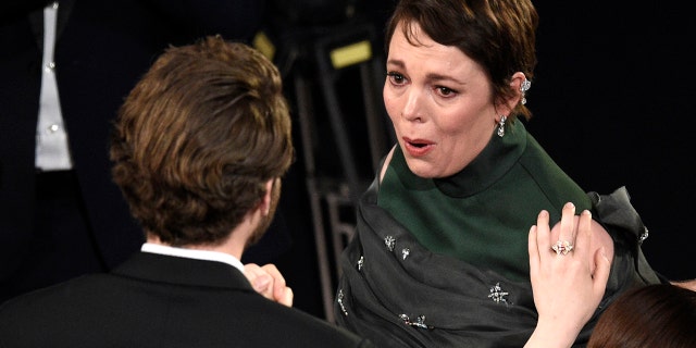 Olivia Colman is congratulated in the audience as she is announced winner of the award for best performance by an actress in a leading role for "The Favourite" at the Oscars on Sunday, Feb. 24, 2019, at the Dolby Theatre in Los Angeles. (Photo by Chris Pizzello/Invision/AP)