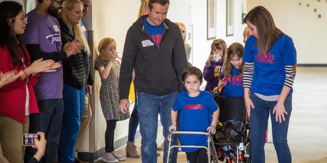 Owen Coulter, 5, uses a walker to help aid his rehabilitation as he makes a full recovery.