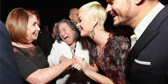 Nancy Pelosi (L), Katy Perry (2nd R) and Orlando Bloom (R) attend MusiCares Person of the Year honoring Dolly Parton at Los Angeles Convention Center on February 8, 2019 in Los Angeles, California.