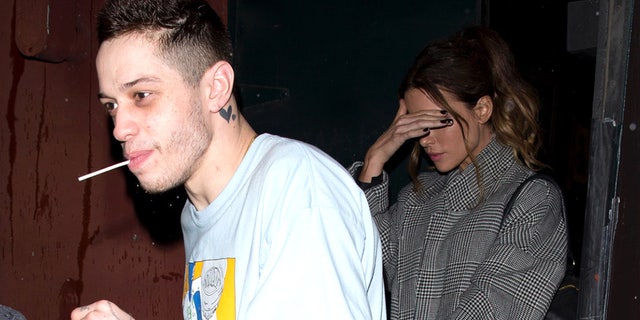 Kate Beckinsale, right, protects her face from the cameras as her boyfriend Pete Davidson drives her out of Largo to the Coronet Comedy Club on February 1, 2019 in Los Angeles, California. 