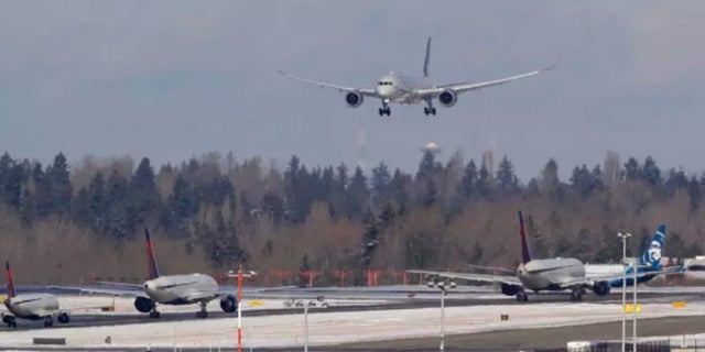 Feb 5: A Virgin Atlantic flight comes in for a landing above other taxiing aircraft, Tuesday, Feb. 5, 2019, at Seattle-Tacoma International Airport in Seattle. (AP Photo/Ted S. Warren)