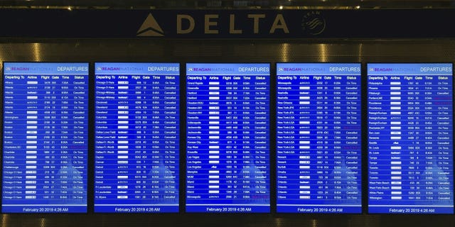 The flight status of dozens of scheduled flights leaving from Ronald Reagan Washington National Airport in Washington D.C. is seen on Feb, 20, 2019.