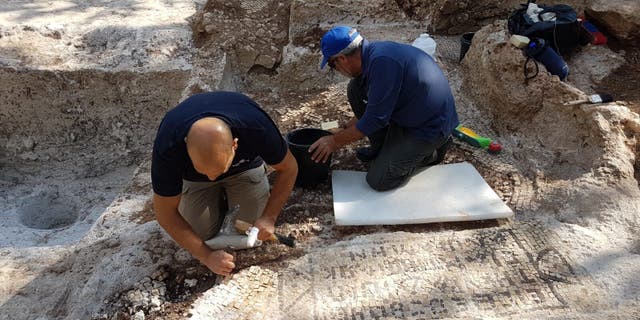 Archaeologists working on the ancient site.