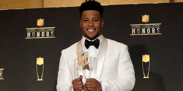 Saquon Barkley, of the New York Giants, poses with the award for AP offensive rookie of the year.  (Photo by AJ Mast/Invision for NFL/AP Images)