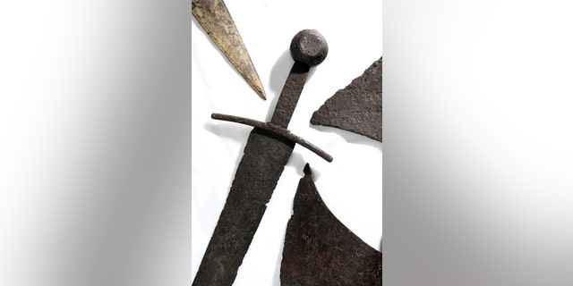A 14th-century sword, surrounded by other artifacts, before they go on display as part of the Secret Rivers exhibition.
