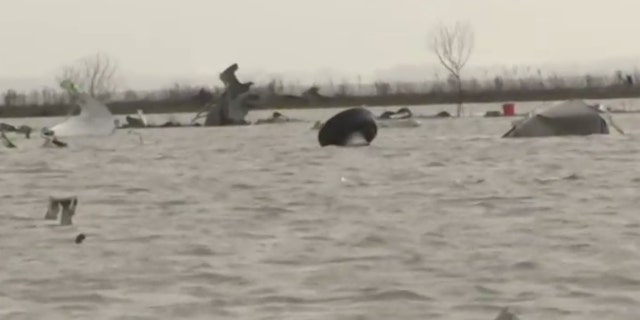 Debris from a crashed cargo plane can be seen in Trinity Bay, Texas on Monday.