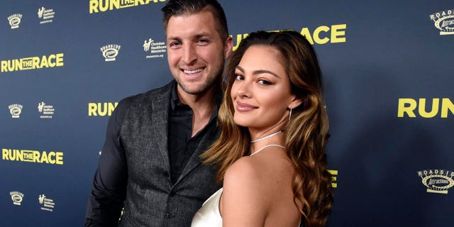 Tim Tebow, left, and Demi-Leigh Nel-Peters attend the "Run the Race" world premiere held at the Egyptian Theatre on Monday, Feb. 11, 2019, in Los Angeles. (Photo by Phil McCarten/Invision for RUN THE RACE, LLC/AP Images)