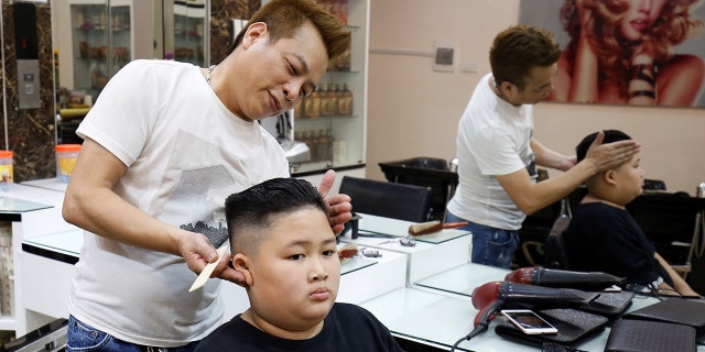 To Gia Huy, 9, has a haircut in a North Korean leader Kim Jong Un style in a haircut salon in Hanoi, Vietnam February 19, 2019.