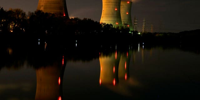 FILE - In this file photo of Nov. 2, 2006, cooling towers of the Three Mile Island nuclear power plant are reflected in the Susquehanna River in this time exposure photograph in Middletown, Pa. Forty years after Three Mile Island became synonymous with America's worst commercial nuclear power accident, the prospect of bailing out nuclear power plants is stirring debate at the highest levels of Pennsylvania and the federal government. (AP Photo/Carolyn Kaster, File)