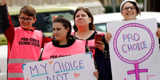 FILE – Abortion rights advocates hold signs in support of choice, at the Capitol in Jackson, Miss., Tuesday, Jan. 22, 2019. The group challenged members of Operation Save America, an anti-abortion organization, who held a rally at the Capitol. (AP Photo/Rogelio V. Solis)