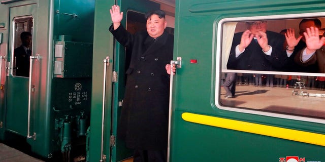 North Korean leader Kim Jong Un waves from a train before leaving Pyongyang Station, North Korea, for Vietnam. 