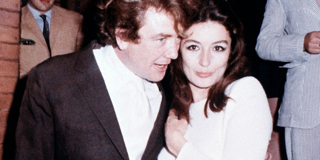 In this 1970 file photo, British actor Albert Finney embraces his bride, French actress Anouk Aimee, after their registry office wedding in London.