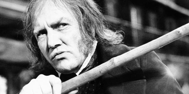 In this Jan. 15, 1970 file photo, British actor Albert Finney waves his cane while playing the title role in "Scrooge," at Shepperton Studios.