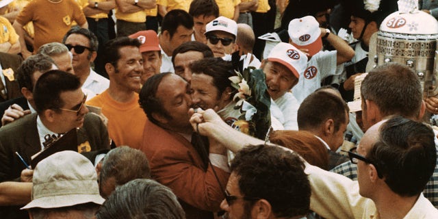 Team owner Andy Granatelli gave Mario Andretti a big kiss after his 1969 Indy 500 victory.