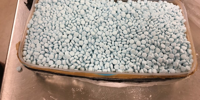 U.S. Drug Enforcement Administration's Phoenix Division shows some of the 30,000 fentanyl pills the agency seized in one of its bigger busts, in Tempe, Ariz., in August, 2017. The picture shows just one of four plastic containers that were stuffed with the tablets. (Drug Enforcement Administration via AP)