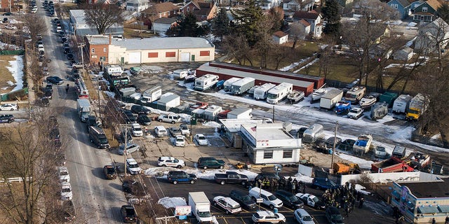 Members of the security forces gathered near the scene of a shootout in an industrial park in Aurora, Illinois on Friday, February 15, 2019.