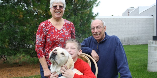 Justin and his grandparents Carl and Michele with Holiday in an old photo