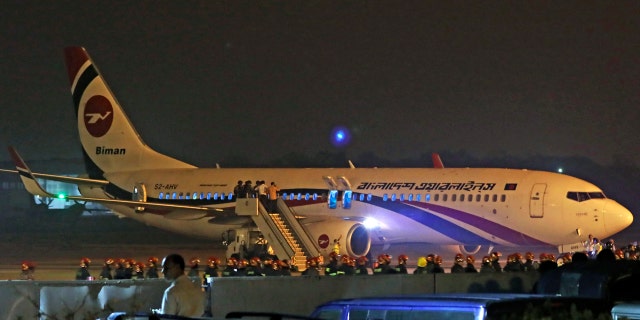 Bangladesh's state-run Biman Bangladesh Airlines flight is seen after it made an emergency landing at the airport in Chittagong, Bangladesh, Sunday, Feb.24, 2019.