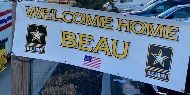 One of the signs greeting Beau Schlichting at his surprise homecoming Saturday in Winthrip, Mass., after a nine-month deployment in Afghanistan with the U.S. Army.