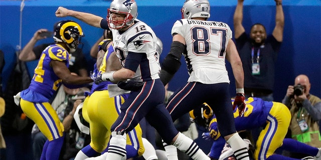 New England Patriots' Tom Brady celebrates a touchdown run by Sony Michel during the second half of the NFL Super Bowl 53 football game against the Los Angeles Rams.