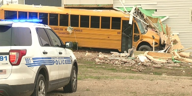 A North Carolina school bus with 15 students and driver crashed into a building on the way to a middle school.