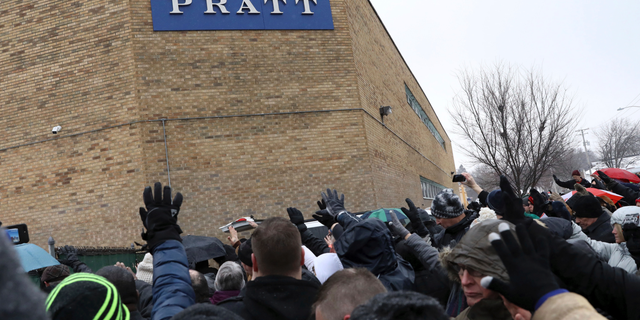 Family, friends and community members attend a vigil Sunday, Feb. 17, 2019, in Aurora, Ill. Six people, including a gunman, died in a shooting at a manufacturing warehouse in Aurora on Friday afternoon, and five officers were struck by gunfire. (AP Photo/Nam Y. Huh)