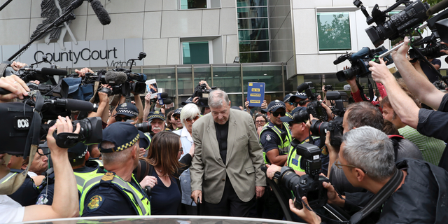 Cardinal George Pell, center, leaves the County Court in Melbourne, Australia, Tuesday, Feb. 26, 2019. The most senior Catholic cleric ever charged with child sex abuse has been convicted of molesting two choirboys moments after celebrating Mass, dealing a new blow to the Catholic hierarchy's credibility after a year of global revelations of abuse and cover-up. (David Crosling/AAP Image via AP)