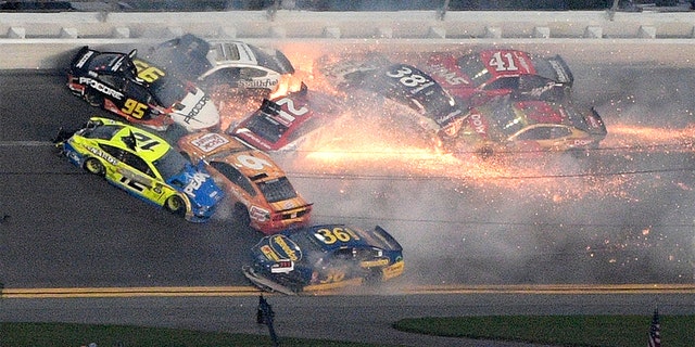 Matt DiBenedetto (95), Ryan Blaney (12), Matt Tifft (36), Aric Almirola (10), Paul Menard (21), Ryan Newman (6), David Ragan (38), Daniel Suarez (41) and Austin Dillon (3) collide between Turns 3 and 4 during the NASCAR Daytona 500 auto race at Daytona International Speedway Sunday in Daytona Beach, Fla. (AP Photo/Phelan M. Ebenhack)