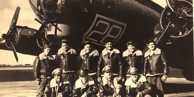 In this image provided by the Kriegshauser family and taken on Oct. 22, 1943 shows the crew posing for a photo in front of a training plane in Geiger Field in Spokane, Washington. They are back row from left: Stf Sgt. Harry Estabrooks, Sgt. Maurice Robbins, Stf Sgt. Robert Mayfield, Sgt. Vito Ambrosio, Sgt. Charles Tuttle and Sgt. George M. Williams. Front row from left: 2nd Lt. Melchor Hernandez, 2nd Lt. John W. Humphrey, 2nd Lt. Lyle Curtis holding the mascot Peanuts and Lt. John G. Kriegshauser.
